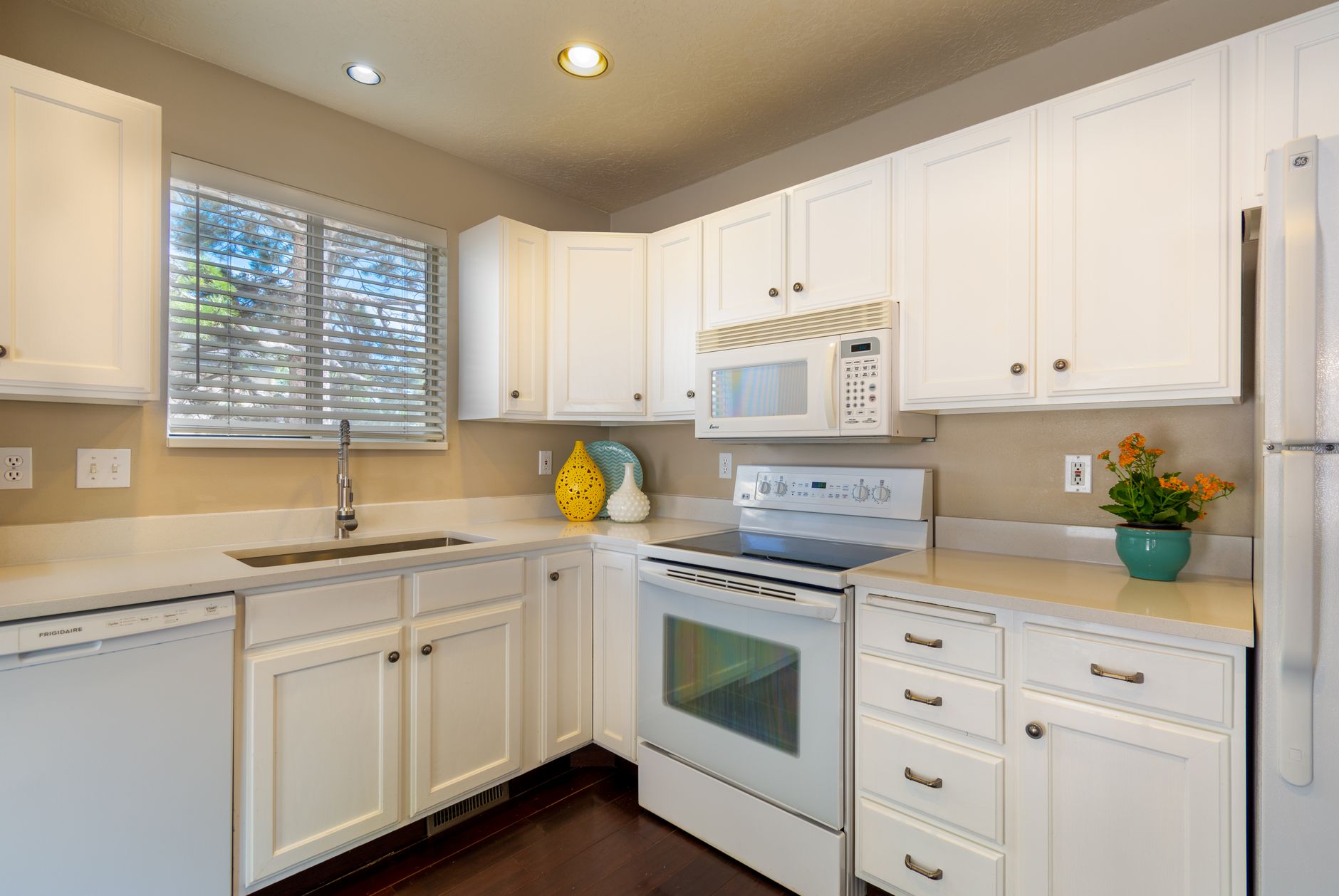 Bright and clean white kitchen featuring modern appliances and sleek design in Carlsbad, CA
